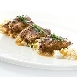 Alitas de pollo sobre cus cus, alioli de lima y fondo de ave Alitas de pollo sobre cus cus, alioli de lima y fondo de ave